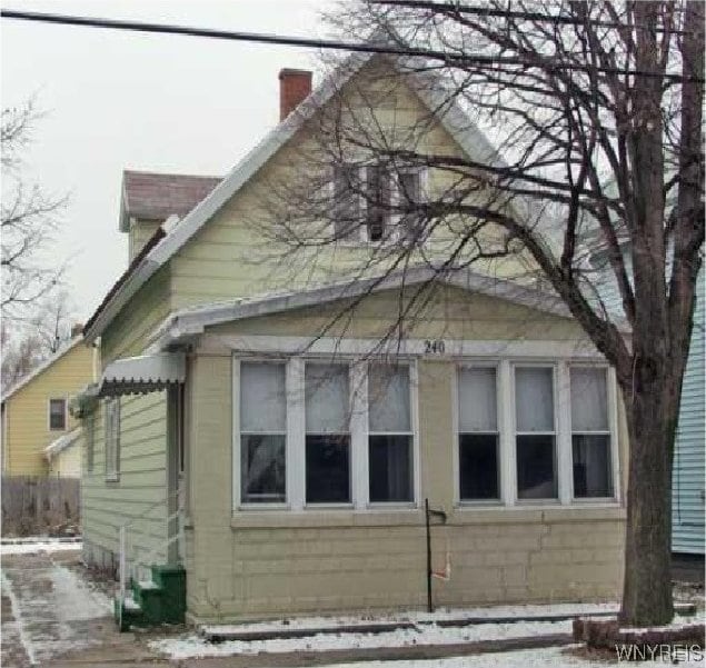 view of property exterior featuring a chimney