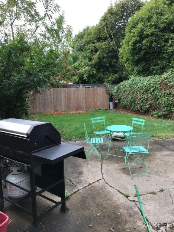 view of patio / terrace with outdoor dining space, grilling area, and fence