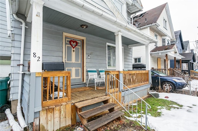 view of exterior entry featuring a porch