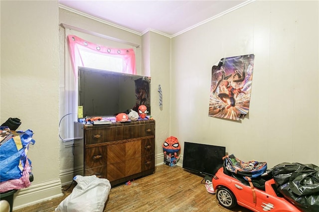 game room featuring ornamental molding and wood finished floors