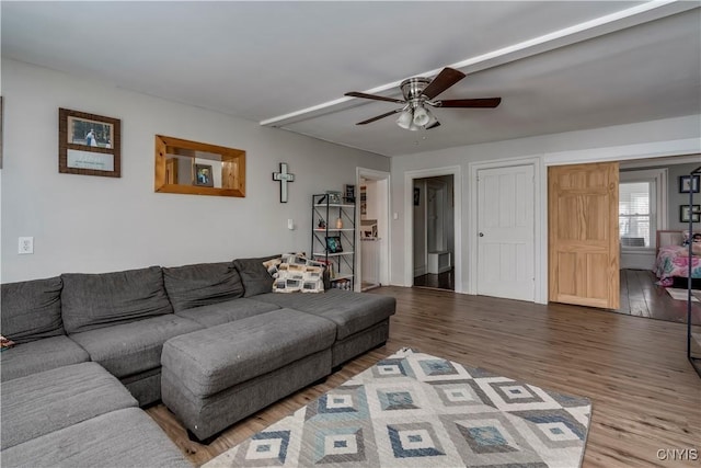 living area with ceiling fan and wood finished floors