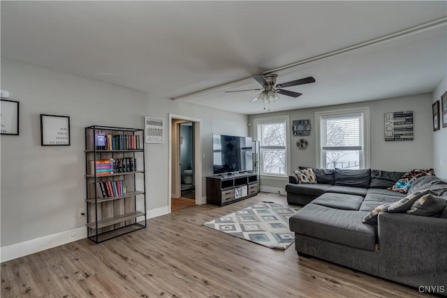 living area with ceiling fan, wood finished floors, and baseboards