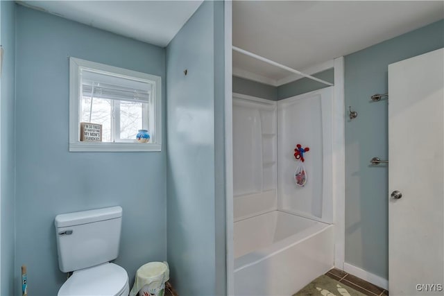 full bathroom with bathing tub / shower combination, tile patterned flooring, and toilet