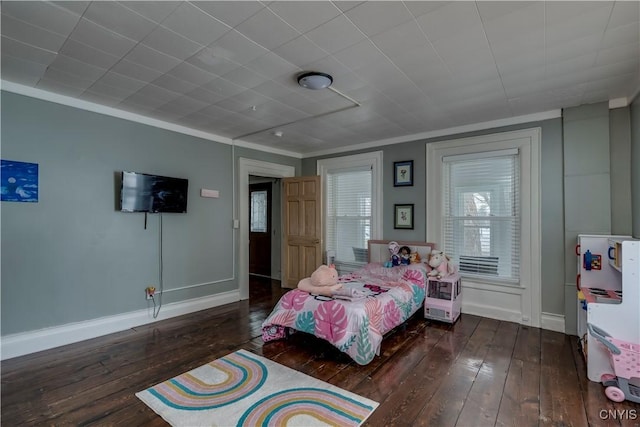 bedroom featuring crown molding, baseboards, and hardwood / wood-style flooring