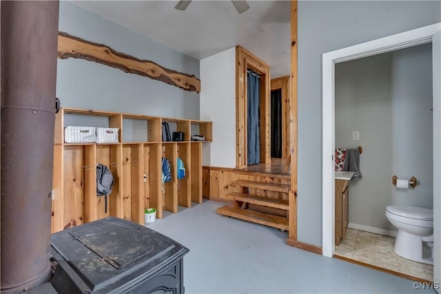 interior space with ceiling fan and toilet