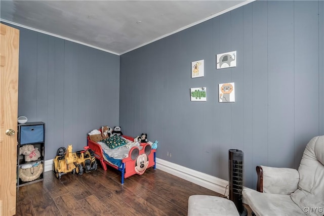 game room featuring ornamental molding, baseboards, and wood finished floors