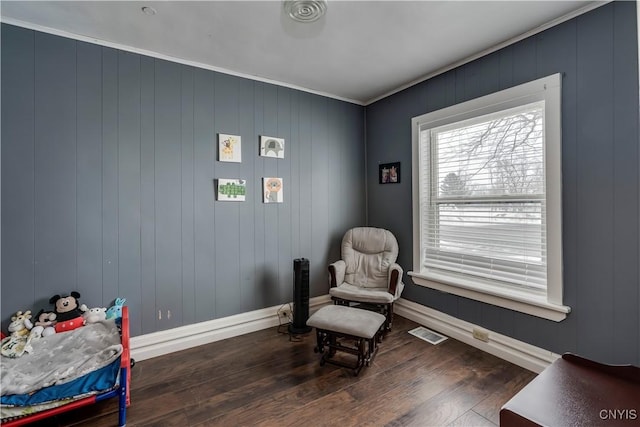 sitting room with dark wood-style floors, baseboards, and visible vents