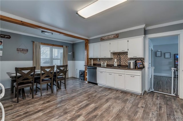 kitchen featuring dark countertops, ornamental molding, dark wood-type flooring, and dishwasher