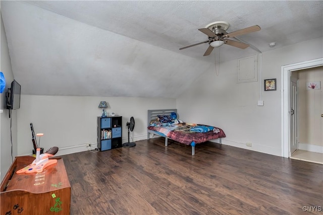 bedroom featuring baseboards, a ceiling fan, lofted ceiling, wood finished floors, and a textured ceiling