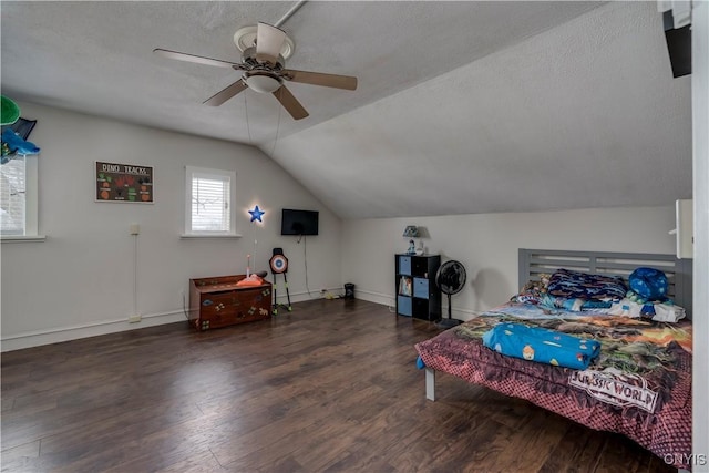 bedroom featuring lofted ceiling, a textured ceiling, wood finished floors, a ceiling fan, and baseboards