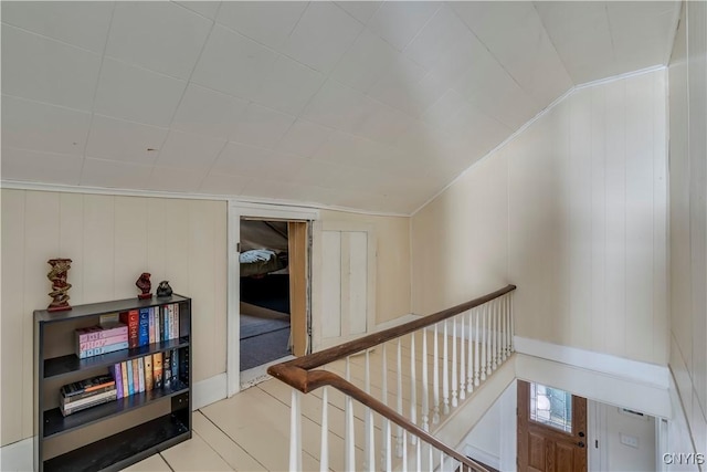 corridor featuring ornamental molding and an upstairs landing