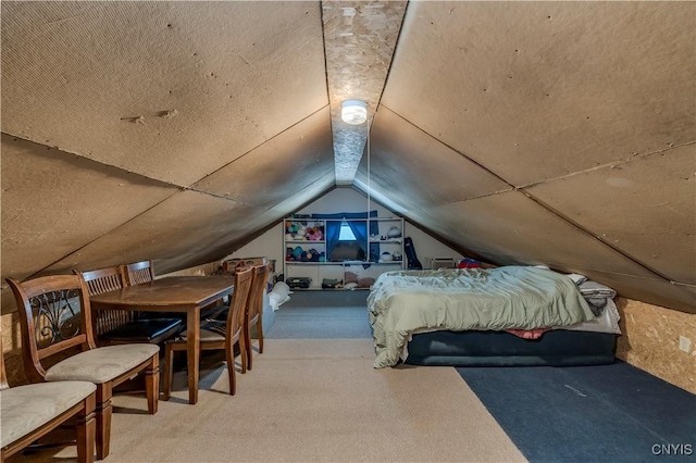 bedroom with vaulted ceiling and carpet flooring