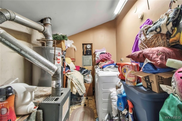 interior space with water heater, vaulted ceiling, and independent washer and dryer