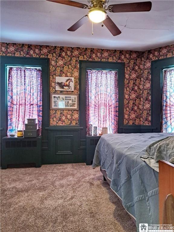 bedroom featuring a ceiling fan and carpet