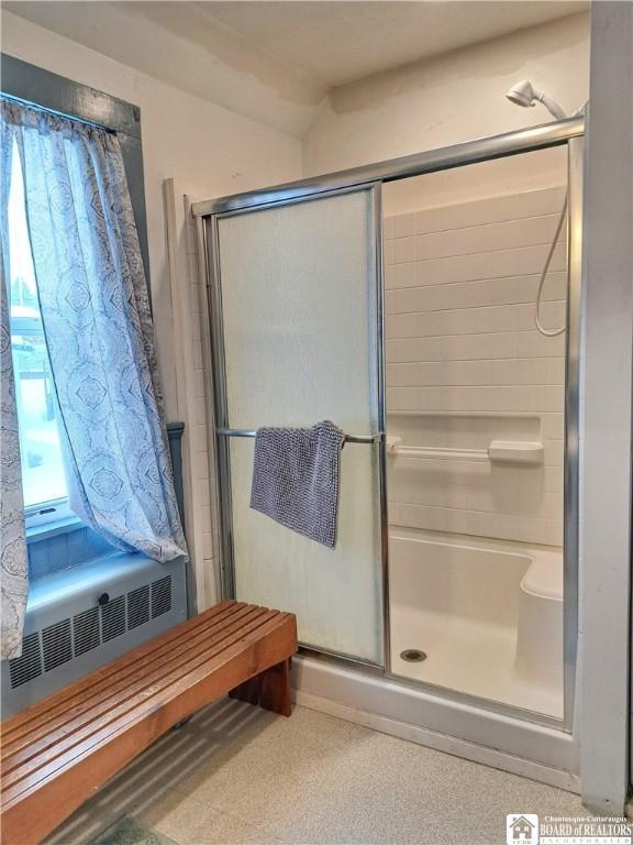 full bath with a shower stall