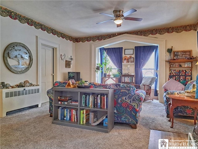 living area with plenty of natural light, radiator heating unit, a ceiling fan, and carpet flooring