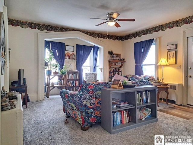 living room featuring plenty of natural light, radiator heating unit, and ceiling fan