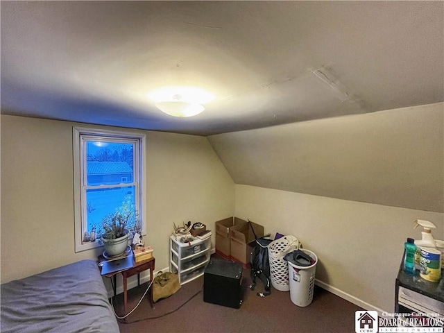 bedroom with lofted ceiling, carpet floors, and baseboards