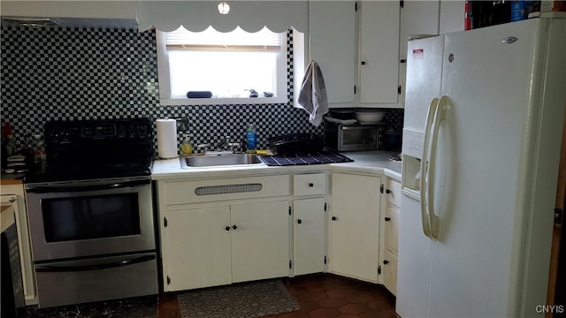 kitchen featuring tile countertops, electric range, white refrigerator with ice dispenser, a sink, and white cabinetry