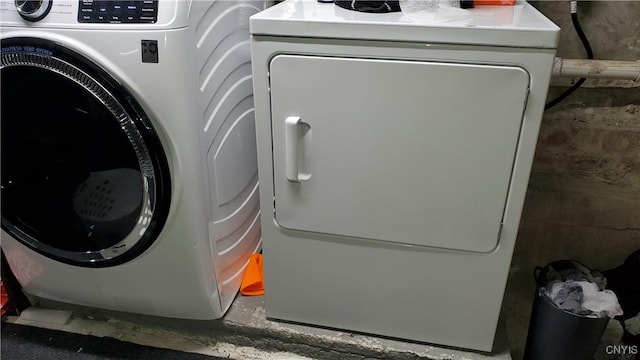 laundry area with concrete block wall and laundry area