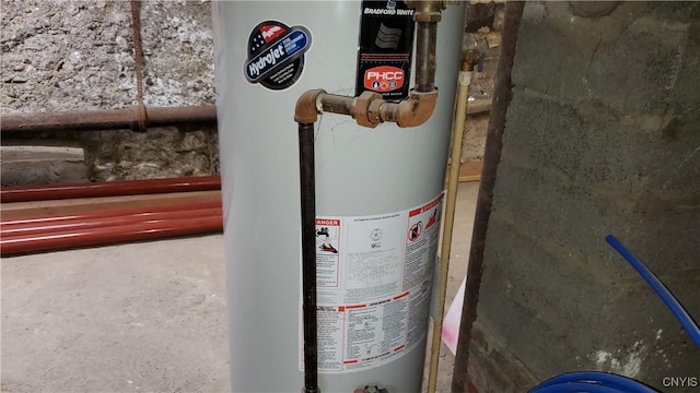 utility room featuring water heater