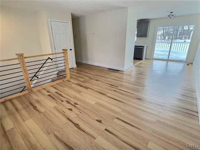 empty room featuring light wood-style floors and baseboards