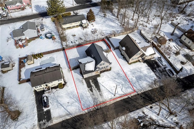 snowy aerial view featuring a residential view