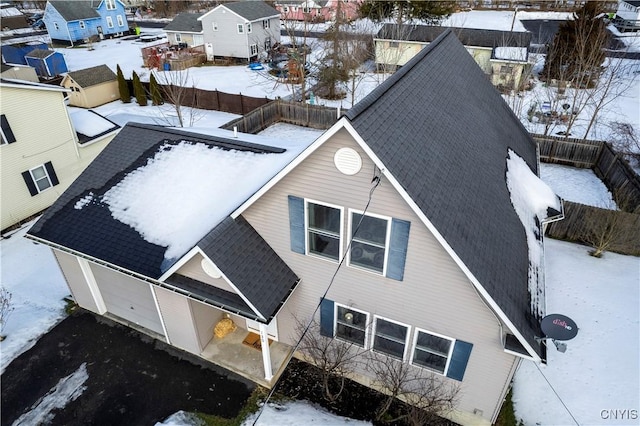 snowy aerial view with a residential view