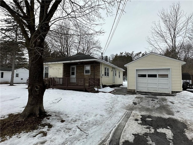 view of front of home with a garage, an outdoor structure, and driveway