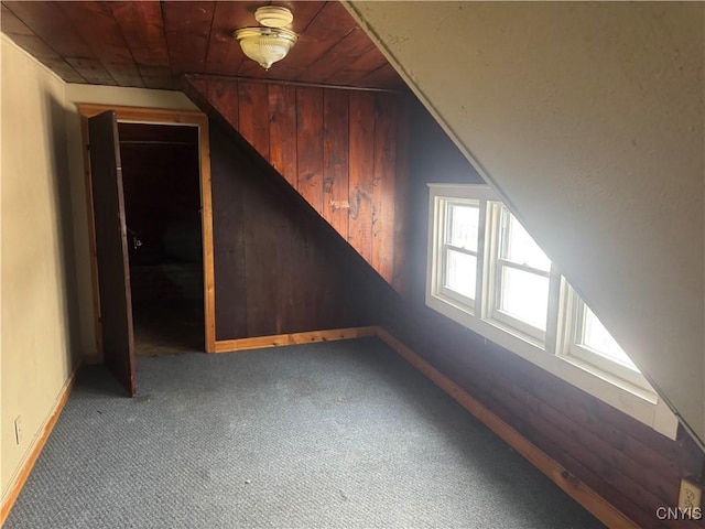 additional living space featuring carpet floors, wood walls, wood ceiling, and lofted ceiling