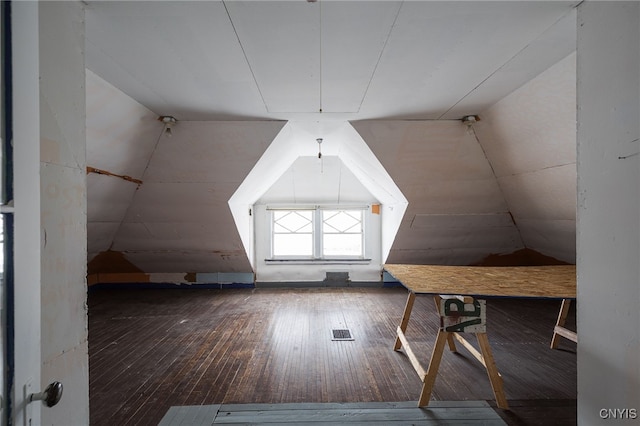 bonus room with lofted ceiling and wood-type flooring