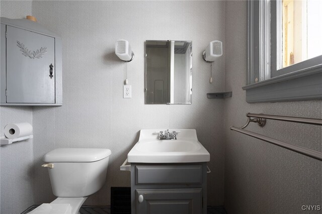 bathroom featuring toilet and vanity