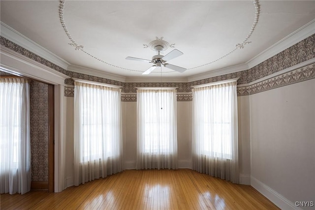 unfurnished room with wallpapered walls, hardwood / wood-style flooring, and crown molding