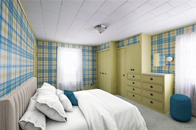 bedroom featuring carpet and wallpapered walls