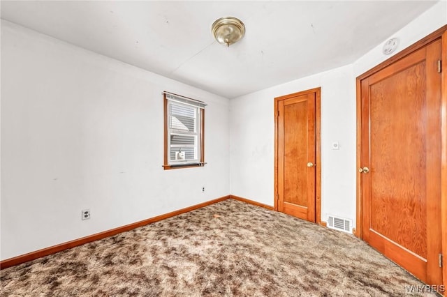 unfurnished bedroom with carpet, visible vents, and baseboards