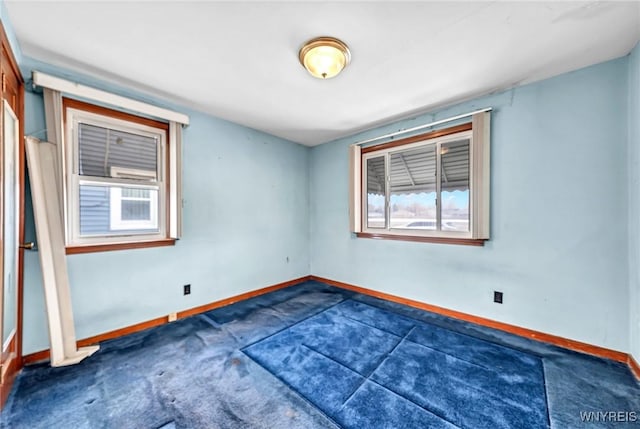 empty room featuring baseboards