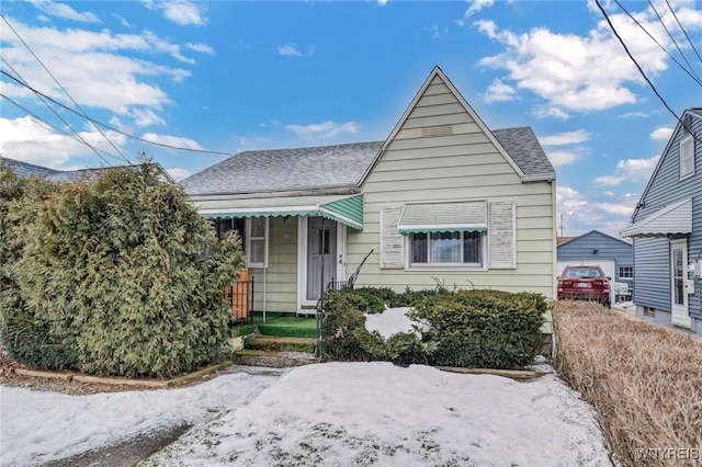 bungalow featuring a shingled roof