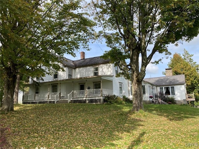 view of front of property featuring a chimney and a front lawn