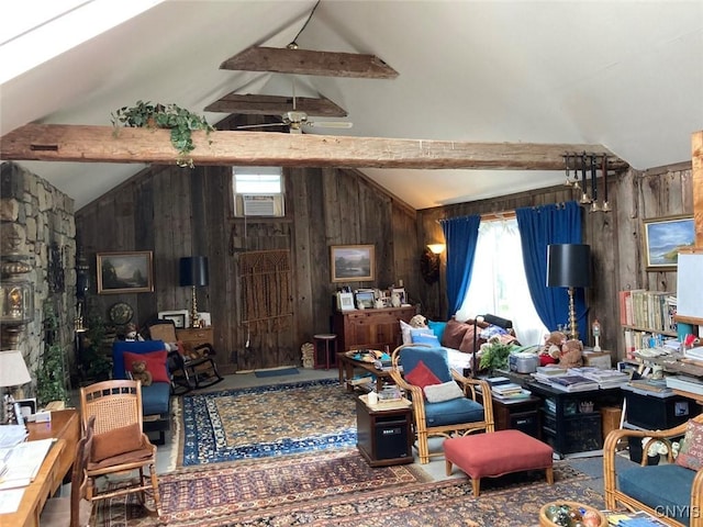 living area with lofted ceiling with beams, a ceiling fan, and wooden walls