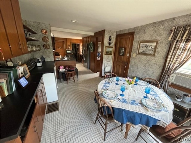 dining space featuring visible vents and cooling unit