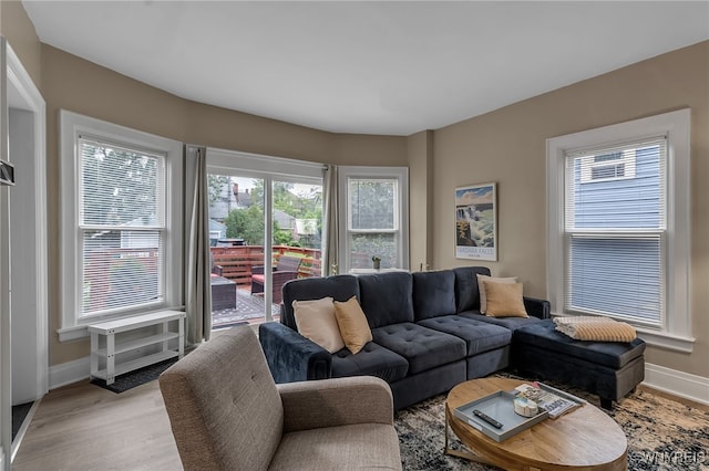 living area with light wood-style flooring and baseboards