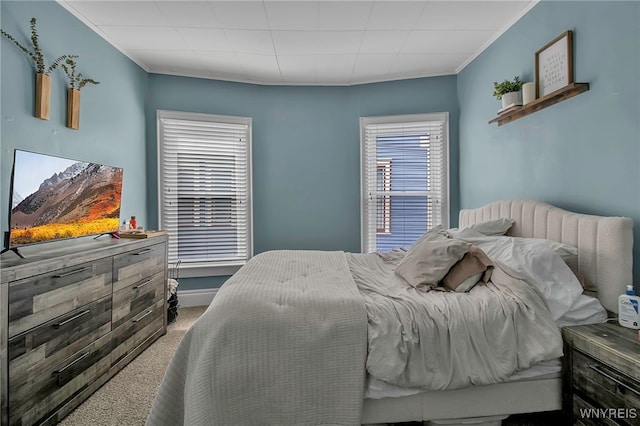 carpeted bedroom featuring crown molding