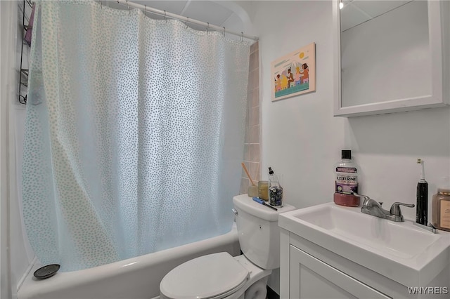 full bathroom with toilet, shower / tub combo with curtain, and vanity