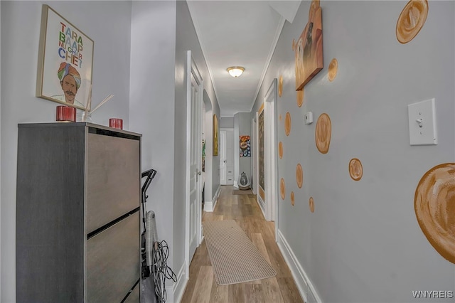 hallway with baseboards and wood finished floors