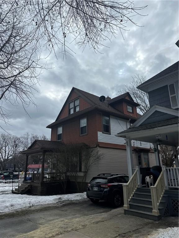 view of side of home with a porch