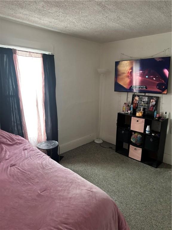 carpeted bedroom with a textured ceiling