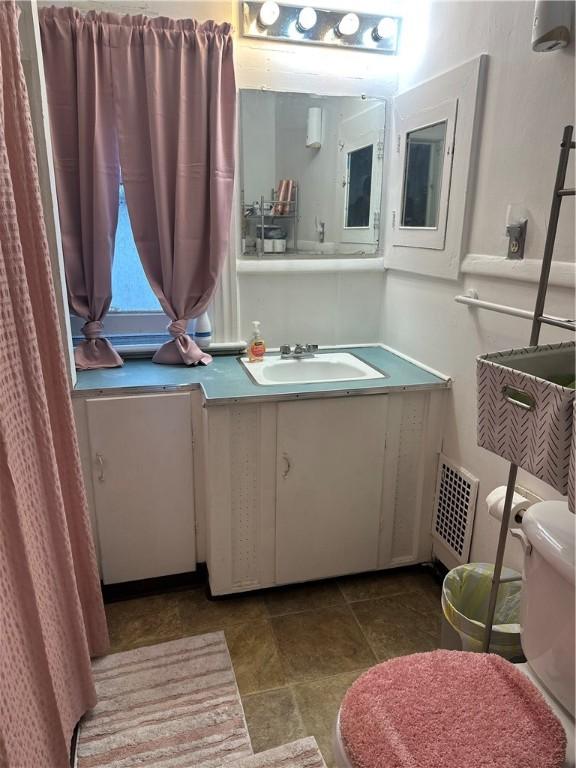 bathroom featuring toilet, visible vents, and vanity