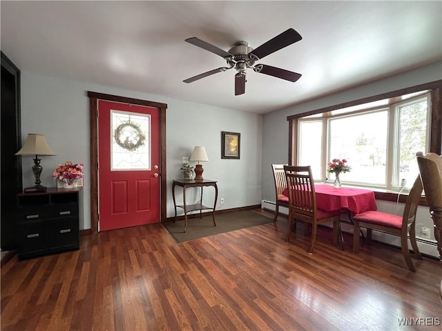 foyer featuring a baseboard radiator, baseboards, and dark wood finished floors