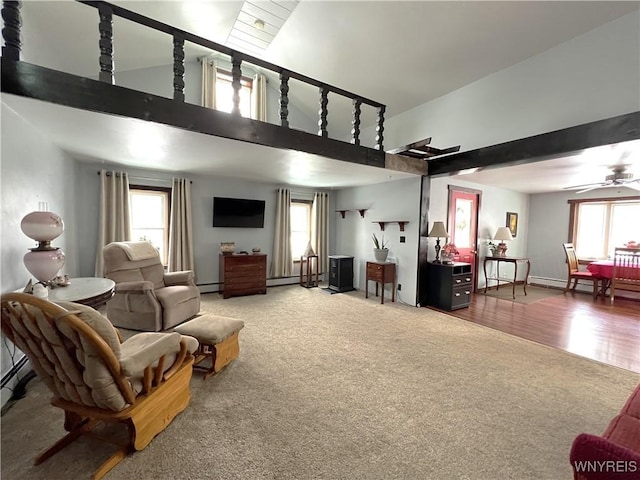 carpeted living area featuring high vaulted ceiling, a baseboard radiator, plenty of natural light, and ceiling fan