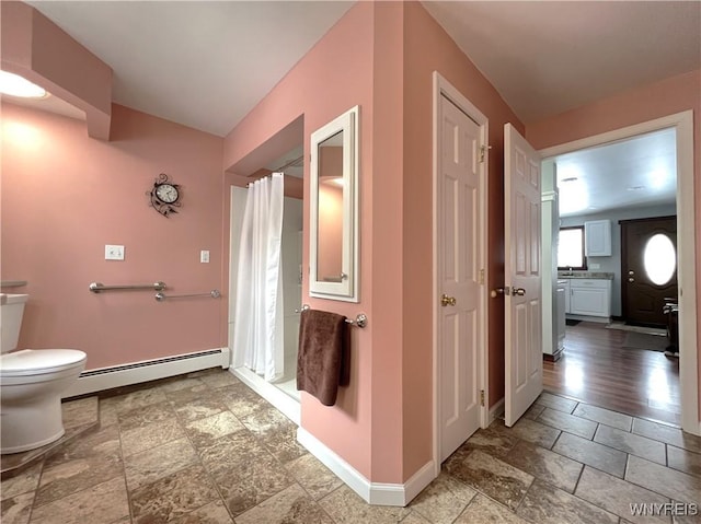 bathroom featuring a baseboard radiator, baseboards, a shower with shower curtain, and toilet